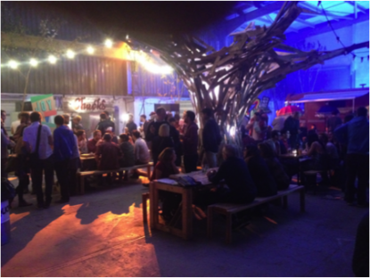 Diners enjoying their culinary delights under The Tree, designed to give the warehouse a sense of the outdoors.