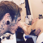 Valyrie owner Justin Oldham tattooing a client