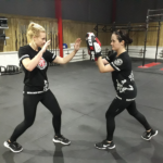 Two women in a fighting stance