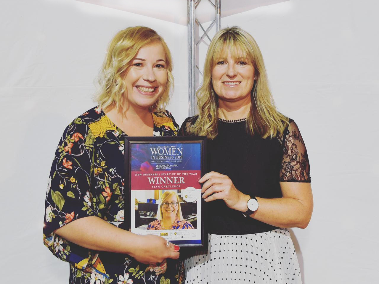 Sian and another woman hold up her Welsh Women in Business award