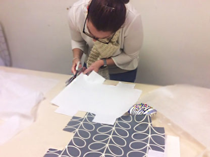 woman cutting fabric for sewing