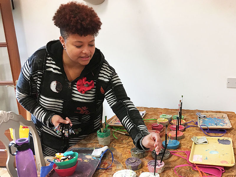 Prince's Trust award winner Natasha Graves setting up art materials for a children's workshop