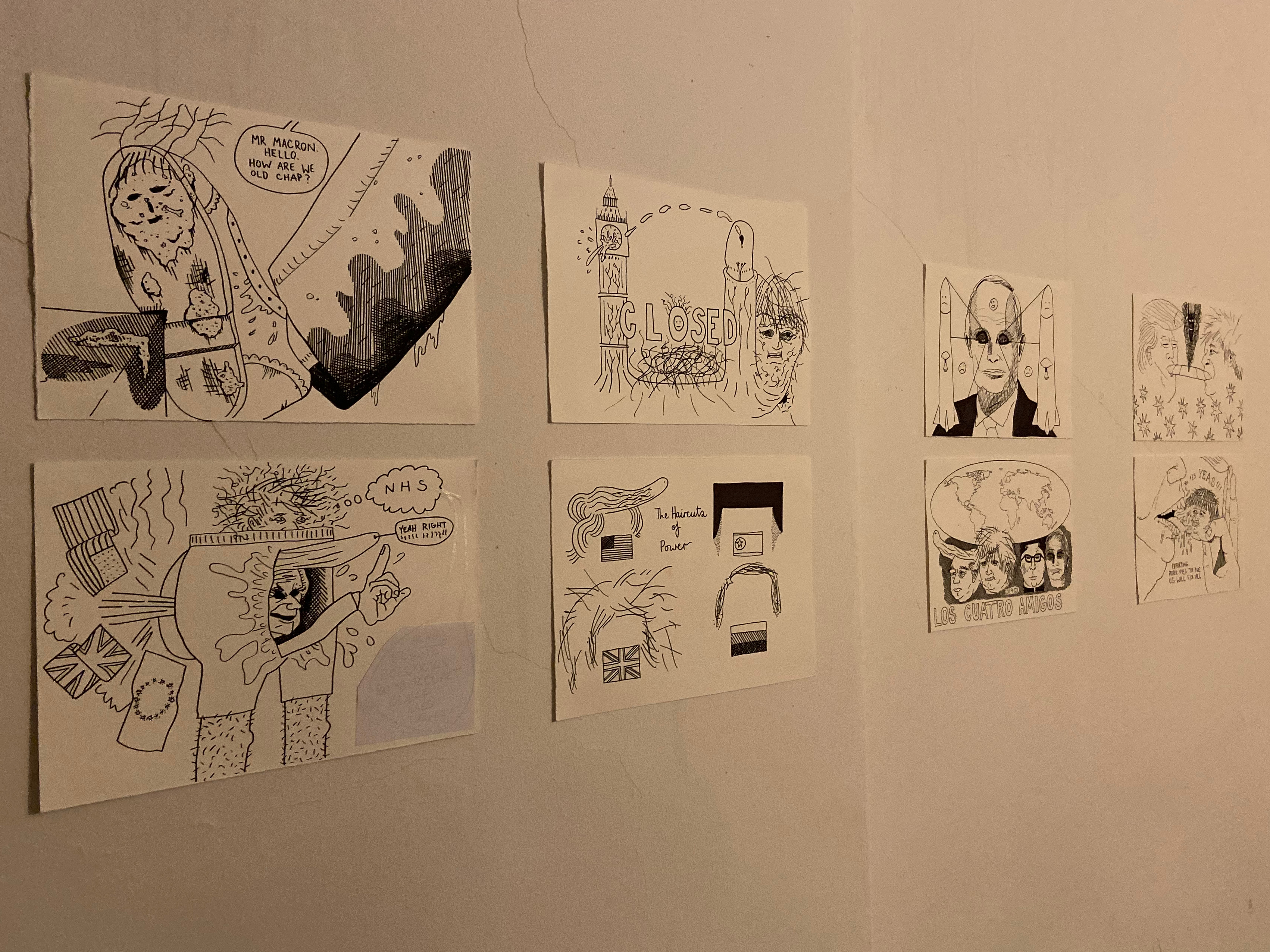 Caricatures are drawn on small pieces of paper and stuck on a toilet wall
