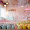Pastel coloured macarons with the shop in the background