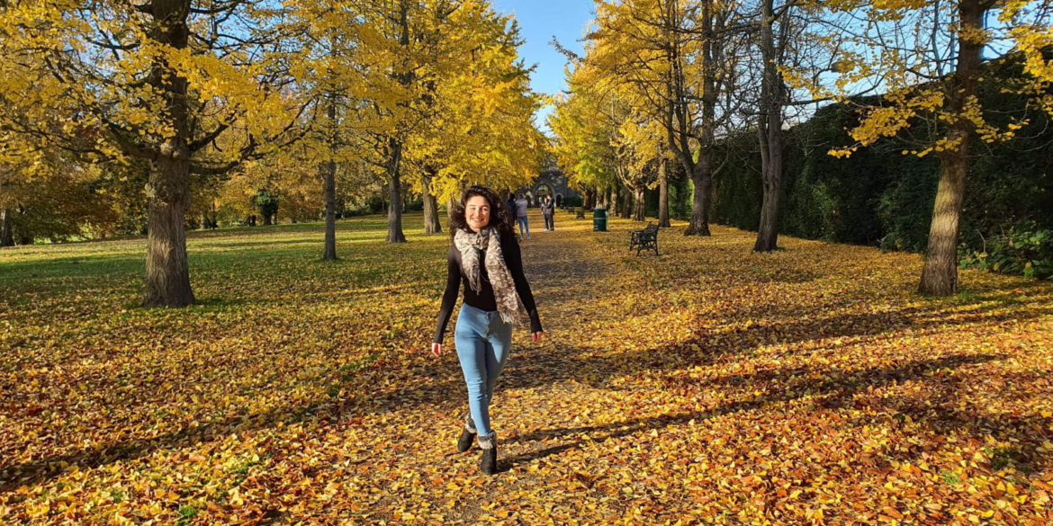 Wendy walking through an autumnal park