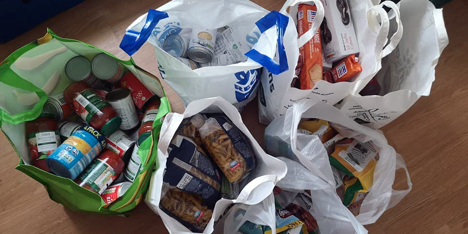 carrier bags filled with food and essential supplies for those in financial difficulty