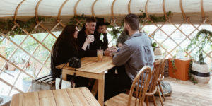 Young people drinking and talking indoors