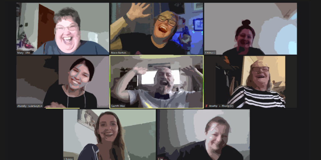 A picture of a zoom call, with 8 people on the screen all laughing
