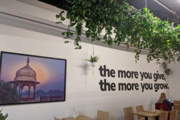 interior of cafe with hanging plants and wall art