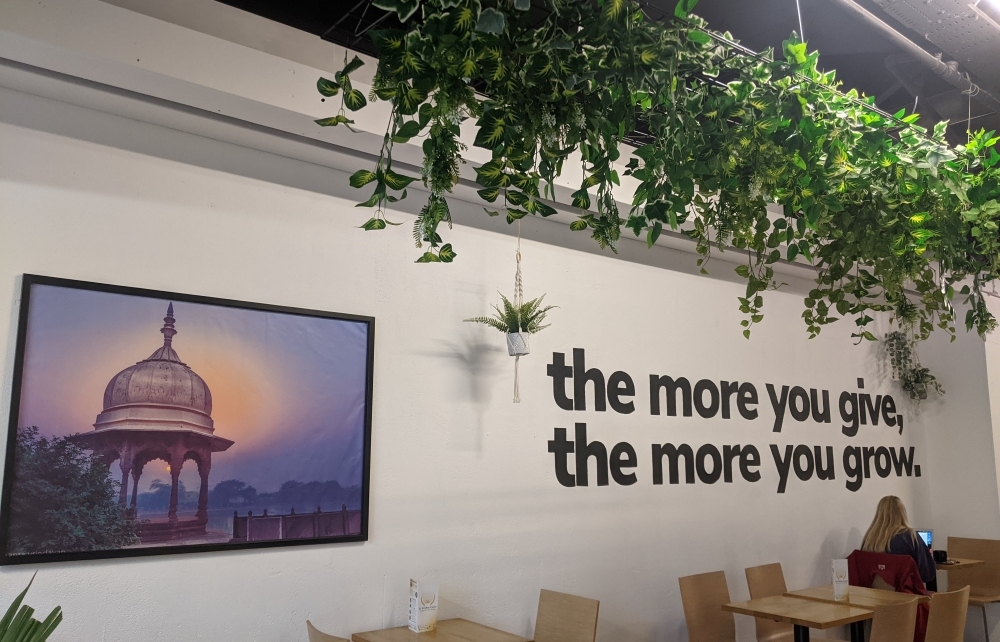 interior of cafe with hanging plants and wall art