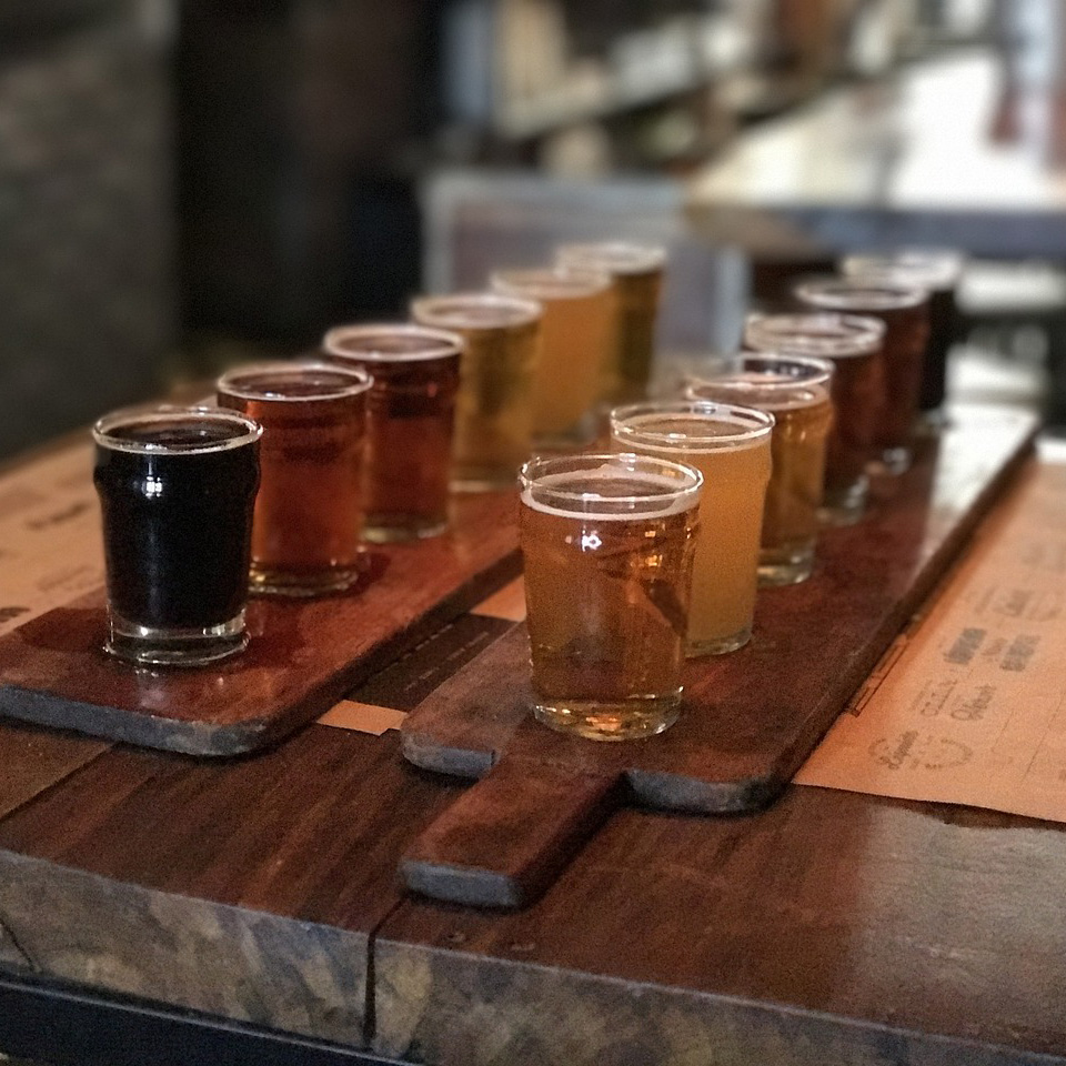 A table with taster glasses of beer from an independent craft brewery 