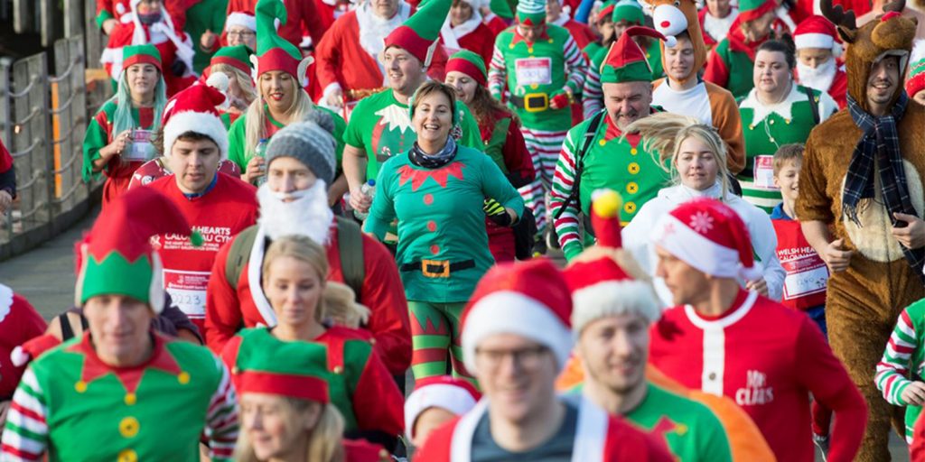 People dressed as Santa Claus, elves, and reindeer participating in the Santa Dash in Cardiff in 2018