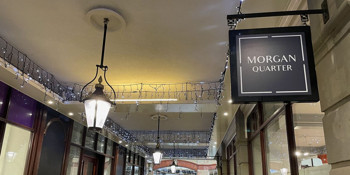 Morgan Quarter sign is on the right and lamps down the corridor can be seen on the left