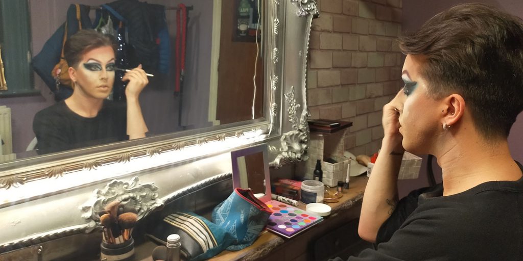 Cardiff drag queen, Polly Amorous, applying drag makeup before his show.