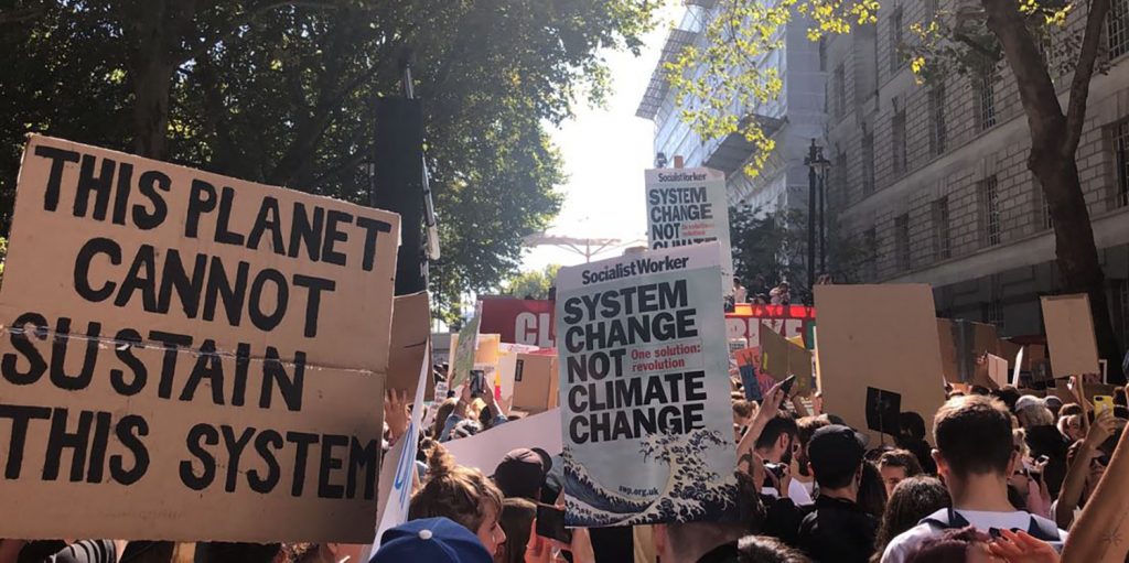 climate protesters holding signs at a climate justice march