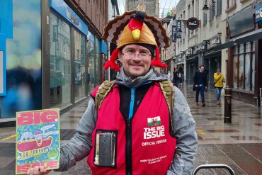 A big issue seller standing outside