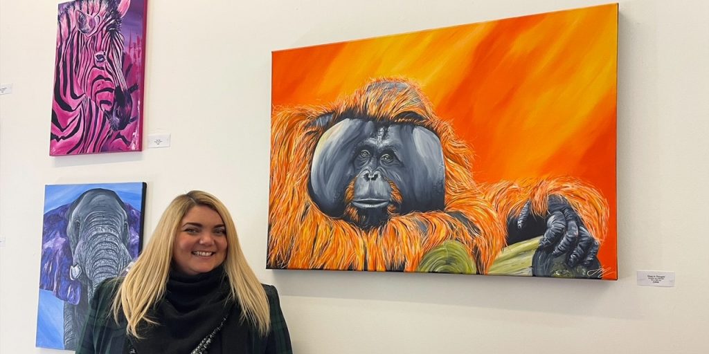 A picture of Welsh artist, Jenna Murphy, together with three of her paintings at Purple Pie Gallery