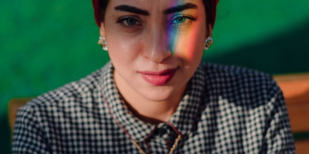 A woman with a rainbow over her left eye
