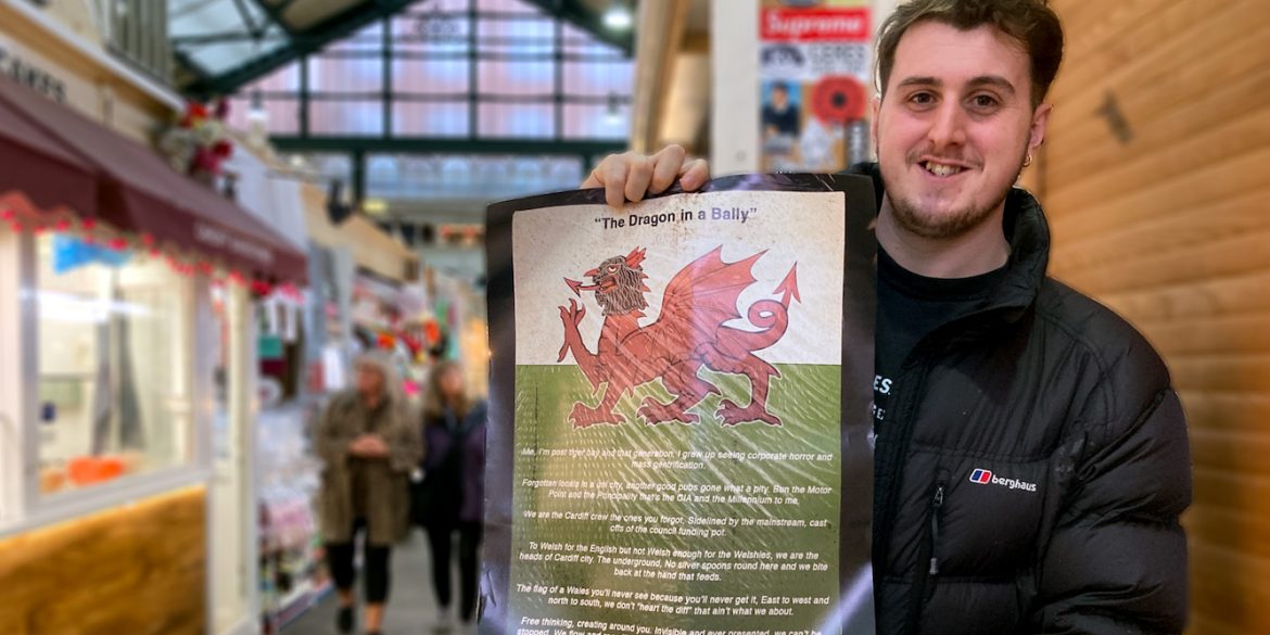 Poet Cal Ellis stands holding a copy of his poem 'The Dragon in a Bally'