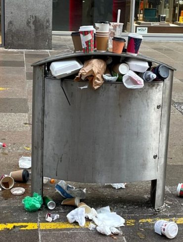 Rubbish oozing out of a bin across St David's at 3pm