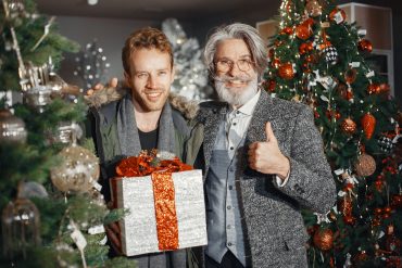Young person helps an older person get into the Christmas spirit