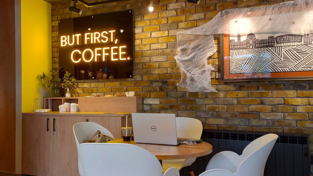 big yellow sign saying 'but first,coffee'