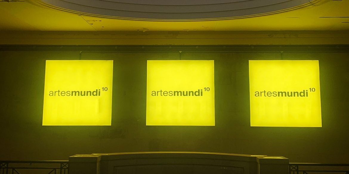 Artes Mundi 10 logo illuminated on the walls of Cardiff's National Museum