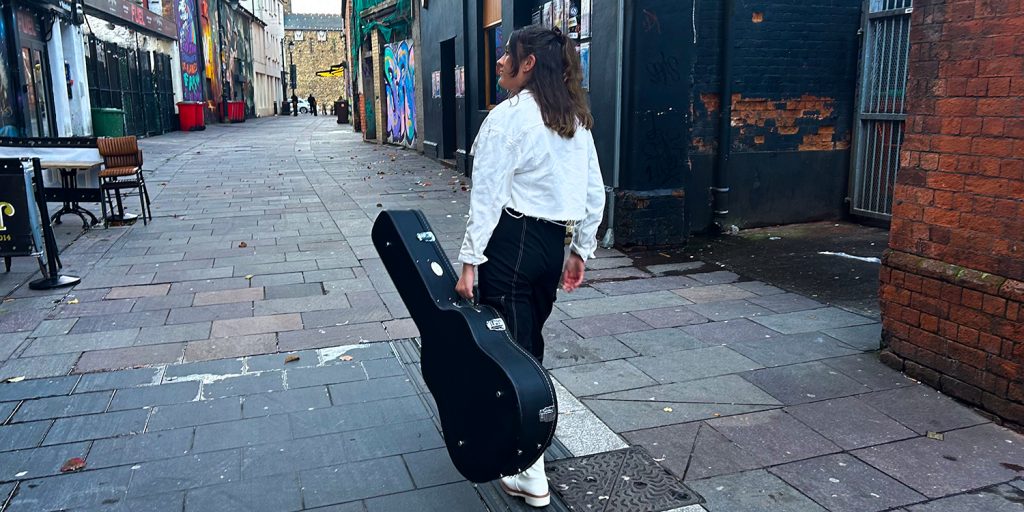 Pictured walking down Womanby street is Ffion Wren, the local musician healing trauma through honest song-writing