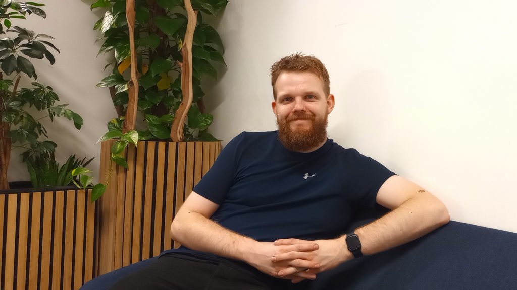 man sitting on couch smiling