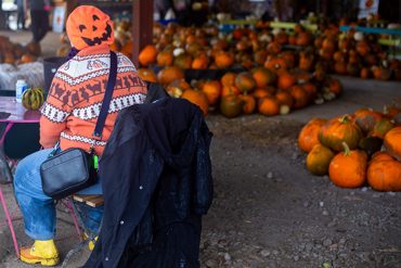 A woman in an orange Halloween jumper and pumpkin beret at Clearwell Farm