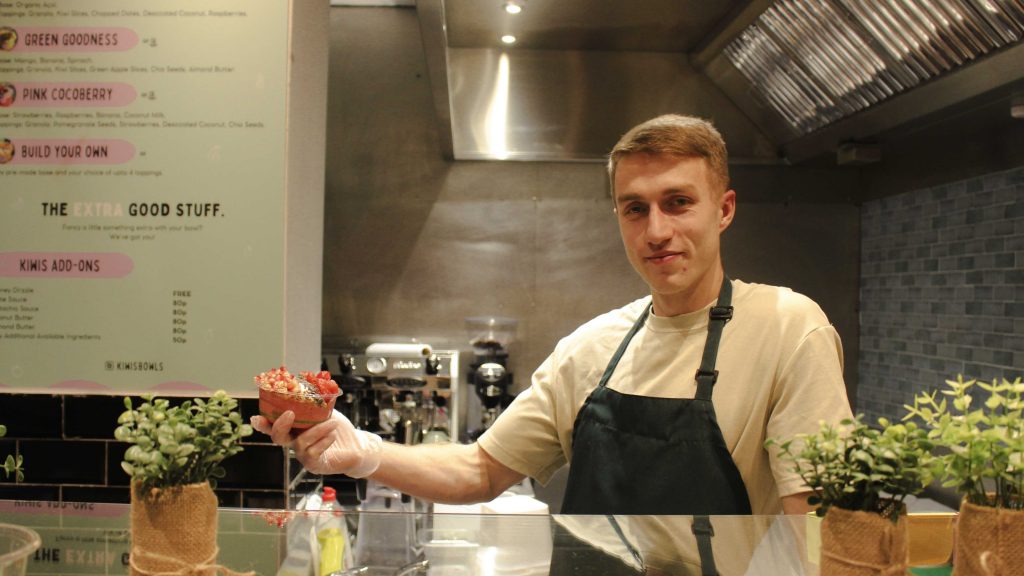 Dan Eedy, the owner of Kiwis Bowls, standing in his shop in Cardiff city centre.