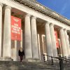 A visitor enters National Museum Cardiff on a sunny day