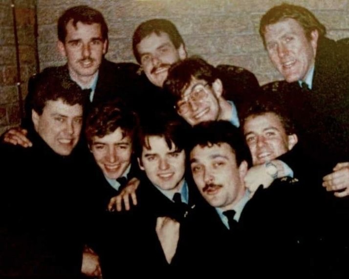 A group of police officers cheer together whilst working during the miners' strikes