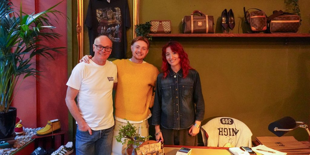 Photo of Jacob Knight with his father and friend behind the shop desk