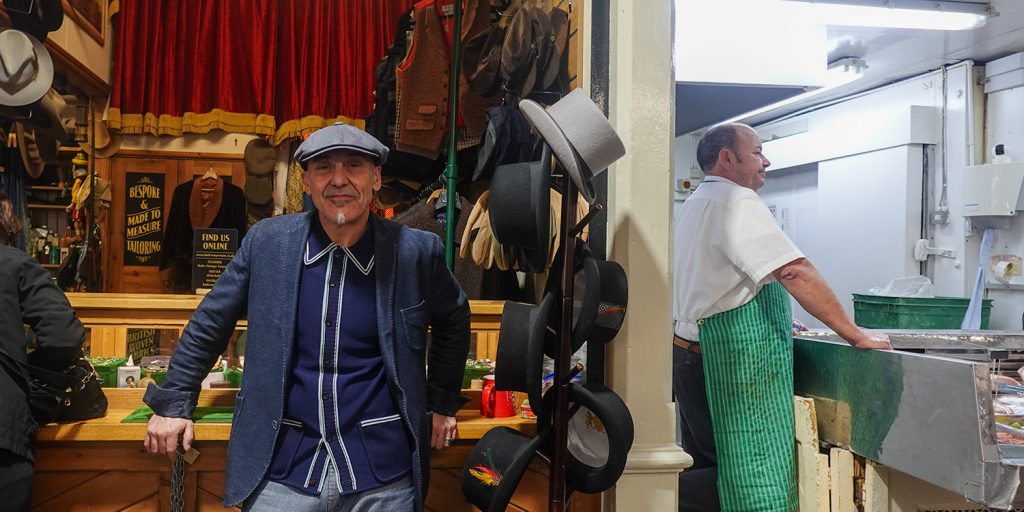 Photo of Stuart Talbot facing forward in front of his shop at Cardiff Market