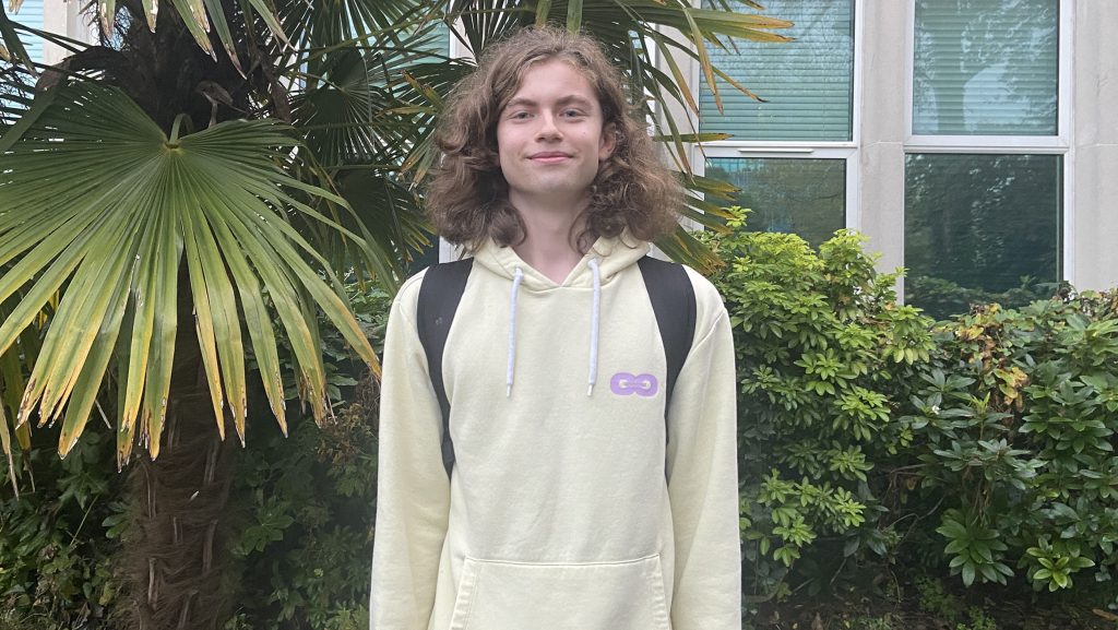 Young astrophotographer, Steffan, posing in front of some greenery