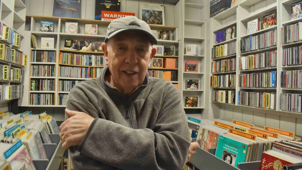 Kellys record store owner, Allan Parkins, in his shop, surrounded by vinyl