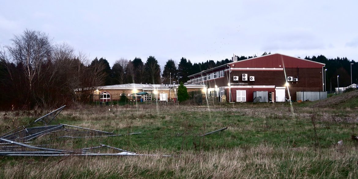 The old Michaelston College site, showing fencing all over the ground and the children's centre in the distance.