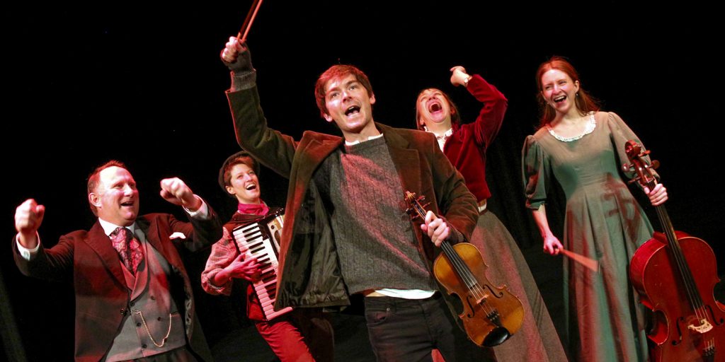 The What the Dickens cast with their instruments
