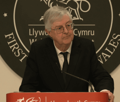 Mark Drakeford stands at a lectern.