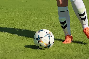 women's football pyramid - A woman's legs kicking a football