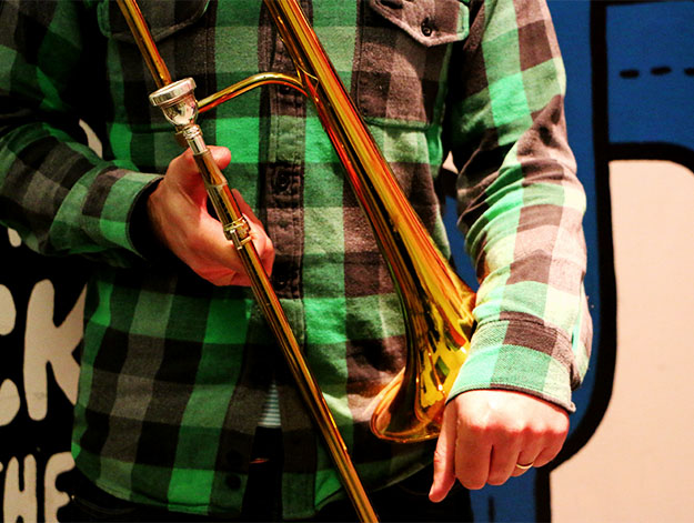 Tom played trombone in Adequate Seven for six years. 
