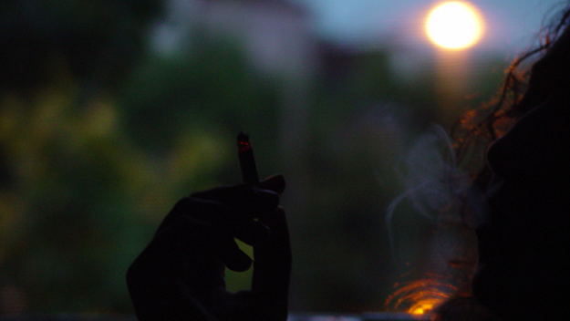Woman smoking at night. 