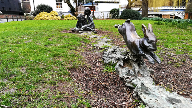 Brass statue to Alice's Adventures in Wonderland in Guildford. 