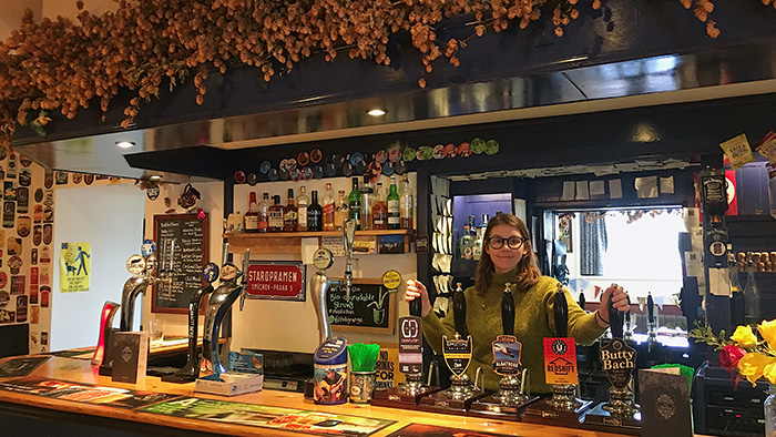 Grange Pub assistant manage behind bar