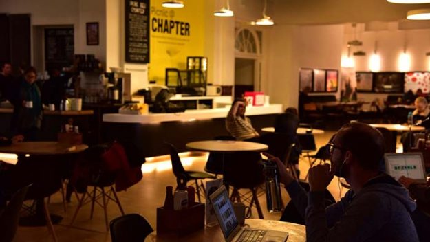 Low lit area with people working in a cafe