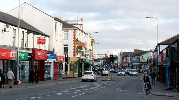 A busy street with cars and bikes