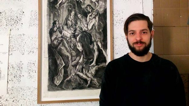 A man stands in front of a charcoal drawing