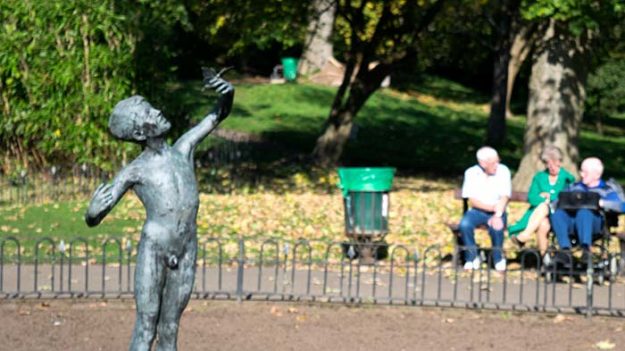 A bronze statues of a nude young boy