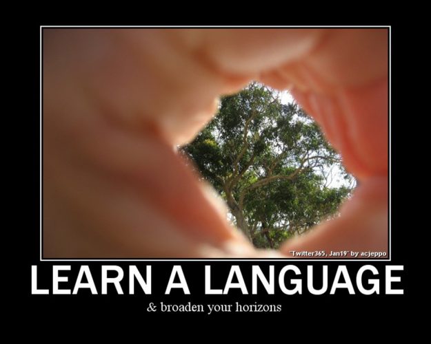 Hands framing trees with text: Learn a language and broaden your horizons